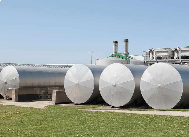 Industrial storage tanks on grassy field