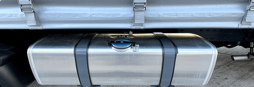 Truck fuel tank with metal straps.