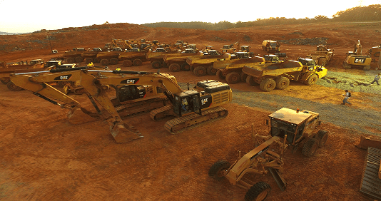 Construction vehicles and equipment on dirt site.